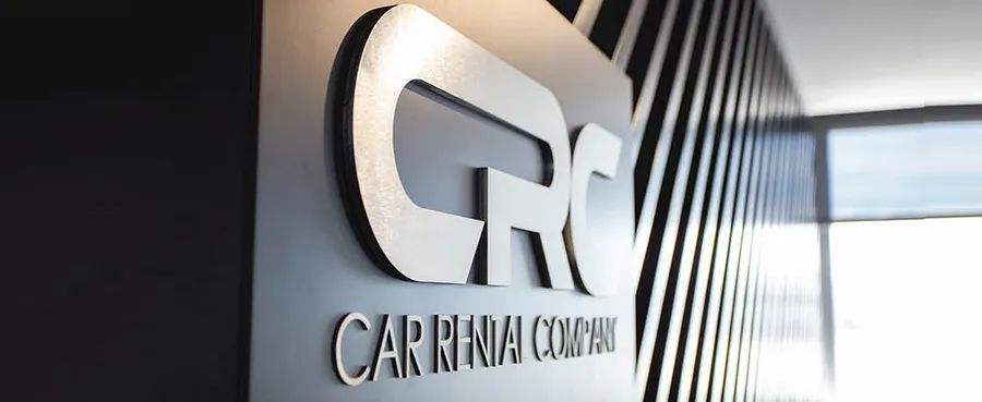 Car rental company logo displayed on wall