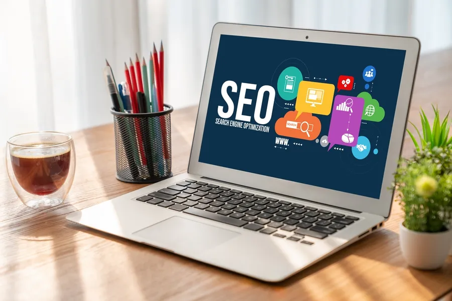 Laptop displaying 'SEO', symbolizing digital marketing strategies for online visibility and optimization.